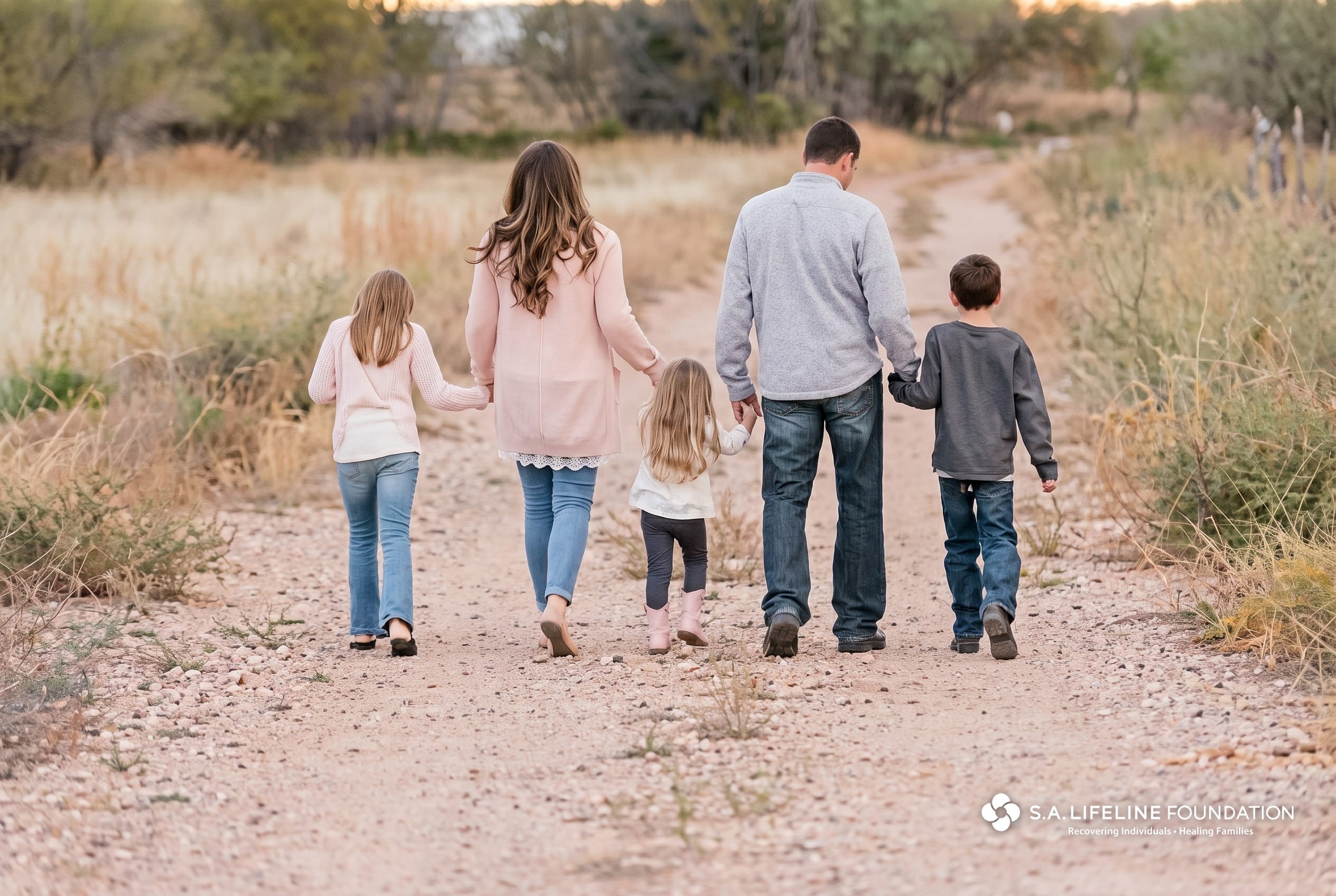 A family walking together through a golden field