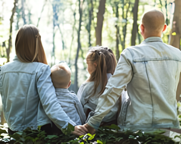 A family sitting together looking at a forest